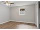 A bright, empty bedroom with wood floors, a ceiling fan, and a closet at 1321 Cloverlawn Ave, Orlando, FL 32806