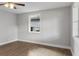 Bright bedroom with a large window, light gray walls, white trim, and wood look vinyl floors at 1321 Cloverlawn Ave, Orlando, FL 32806