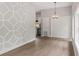 Bright dining room features a chandelier and decorative wall, with a view into the kitchen at 1321 Cloverlawn Ave, Orlando, FL 32806