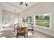 Bright dining area with a glass table, modern lighting, and large windows overlooking the landscaped yard at 1321 Cloverlawn Ave, Orlando, FL 32806