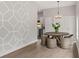 Charming dining room featuring geometric wall details, a chandelier, and hardwood floors at 1321 Cloverlawn Ave, Orlando, FL 32806