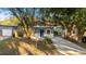 Cozy gray house with a blue front door and neatly paved driveway at 1321 Cloverlawn Ave, Orlando, FL 32806