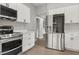 Well-equipped kitchen features stainless steel appliances and white shaker cabinets at 1321 Cloverlawn Ave, Orlando, FL 32806