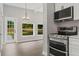 Kitchen/dining area featuring stainless steel appliances, bright cabinets and a view to the backyard at 1321 Cloverlawn Ave, Orlando, FL 32806