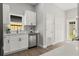 Modern kitchen featuring white cabinets, stainless steel appliances, and quartz countertops, with a bright window view at 1321 Cloverlawn Ave, Orlando, FL 32806