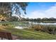 Picturesque lakeside scene with lily pads, lush greenery, and a bench, perfect for enjoying nature's tranquility at 1321 Cloverlawn Ave, Orlando, FL 32806