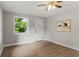 Living room featuring laminate wood floors, front door, and a front-yard view window at 1321 Cloverlawn Ave, Orlando, FL 32806