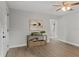 Updated living room features laminate wood floors and view to the updated bathroom at 1321 Cloverlawn Ave, Orlando, FL 32806