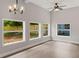 Bright living room with a ceiling fan, decorative lighting, and natural light from large windows at 1321 Cloverlawn Ave, Orlando, FL 32806