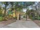 Welcoming entrance to Hourglass Park, featuring a gated entry and signage amidst lush greenery and mature trees at 1321 Cloverlawn Ave, Orlando, FL 32806