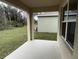 Covered patio overlooking backyard and wooded area at 2008 Red Rock Rd, New Smyrna Beach, FL 32168