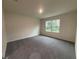 Bright bedroom with carpet flooring and a large window at 2008 Red Rock Rd, New Smyrna Beach, FL 32168