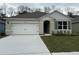 Two-story home with white siding, gray roof, and a two-car garage at 2008 Red Rock Rd, New Smyrna Beach, FL 32168