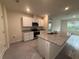 Modern kitchen with white cabinets, granite countertops, and stainless steel appliances at 2008 Red Rock Rd, New Smyrna Beach, FL 32168