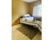 Cozy bedroom with a full-size bed and patterned rug at 2677 Tansboro Dr, Deltona, FL 32725