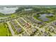 Aerial view showcasing a house in a community by a lake at 16467 Olive Hill Dr, Winter Garden, FL 34787