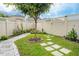 Landscaped backyard with stone pathways and lush greenery at 16467 Olive Hill Dr, Winter Garden, FL 34787