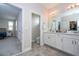 Double vanity bathroom with walk-in shower and access to closet at 16467 Olive Hill Dr, Winter Garden, FL 34787
