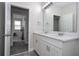 Double vanity bathroom with white cabinets and view of bedroom at 16467 Olive Hill Dr, Winter Garden, FL 34787