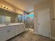 Elegant bathroom with double vanity and large walk-in shower at 16467 Olive Hill Dr, Winter Garden, FL 34787