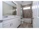 Bathroom boasts double vanity, shower/tub combo, and grey tile at 16467 Olive Hill Dr, Winter Garden, FL 34787