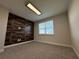Spacious bedroom with wood-like accent wall and neutral carpeting at 16467 Olive Hill Dr, Winter Garden, FL 34787