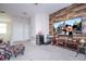 Bonus room with large TV, wood accent wall, and comfy seating at 16467 Olive Hill Dr, Winter Garden, FL 34787
