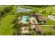 Aerial view of community pool area with palm trees and clubhouse at 16467 Olive Hill Dr, Winter Garden, FL 34787