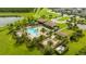 Aerial view of community pool, clubhouse, and surrounding green space at 16467 Olive Hill Dr, Winter Garden, FL 34787