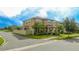 Two-story house with a tan exterior, landscaping, and a fenced yard at 16467 Olive Hill Dr, Winter Garden, FL 34787