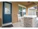 Front porch with rocking chairs and brick columns at 16467 Olive Hill Dr, Winter Garden, FL 34787
