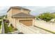 Tan garage with a paver driveway and a white fence at 16467 Olive Hill Dr, Winter Garden, FL 34787