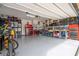 Well-organized garage with ample storage and workbench at 16467 Olive Hill Dr, Winter Garden, FL 34787