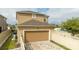 Tan garage with a paver driveway and a white fence at 16467 Olive Hill Dr, Winter Garden, FL 34787