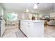 Modern white kitchen with island, open to dining and living areas at 16467 Olive Hill Dr, Winter Garden, FL 34787
