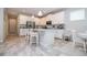 Modern kitchen with white cabinets and island, open to dining area at 16467 Olive Hill Dr, Winter Garden, FL 34787