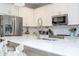 Modern kitchen with stainless steel appliances and white cabinetry at 16467 Olive Hill Dr, Winter Garden, FL 34787