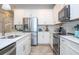 Well-equipped kitchen, stainless steel appliances, and white cabinets at 16467 Olive Hill Dr, Winter Garden, FL 34787