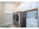 Bright laundry room with washer, dryer, and ample cabinetry at 16467 Olive Hill Dr, Winter Garden, FL 34787
