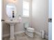 Charming powder room with pedestal sink and toilet at 16467 Olive Hill Dr, Winter Garden, FL 34787