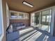 Relaxing sunroom featuring comfortable seating and large windows at 16467 Olive Hill Dr, Winter Garden, FL 34787