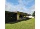 Exterior shot showcasing a well maintained lawn and the back side of the home at 20319 Macon Pkwy, Orlando, FL 32833