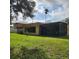 Exterior shot showing a screened in patio and lush backyard at 20319 Macon Pkwy, Orlando, FL 32833