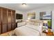 Well-lit bedroom with plush rug, stylish decor and a view to the outside at 20319 Macon Pkwy, Orlando, FL 32833