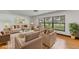 Bright living room with large windows, stylish furniture and decor, and hardwood floors at 20319 Macon Pkwy, Orlando, FL 32833
