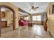 Bright living room with tile floors, red couch, and ceiling fan at 132 N Hastings St, Orlando, FL 32835