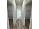 Hallway with wood-look floors and double closets with wire shelving at 3325 Sw 165Th Loop, Ocala, FL 34473