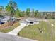 An aerial view of the single-Gathering home, showing the roof, lawn, and driveway in a picturesque setting at 15062 Sw 63Rd Court Rd, Ocala, FL 34473