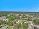 Expansive aerial view of a neighborhood nestled among lush green trees and a clear blue sky at 15062 Sw 63Rd Court Rd, Ocala, FL 34473