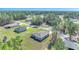 An aerial view of the single-Gathering home showing the roof, lawn, and driveway in a picturesque setting at 15062 Sw 63Rd Court Rd, Ocala, FL 34473